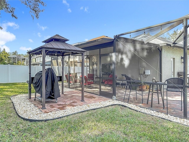 exterior space featuring a lawn, a patio area, and a lanai