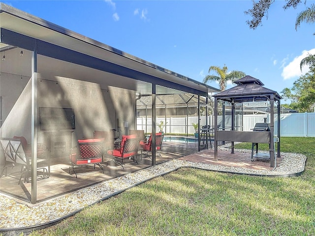 view of yard with a gazebo, a fenced in pool, glass enclosure, and a patio area