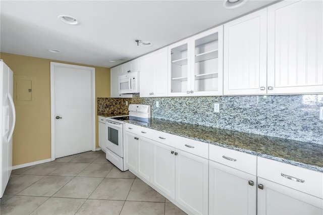 kitchen featuring white appliances, white cabinetry, and dark stone countertops