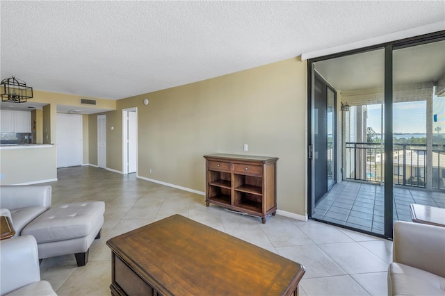 living room with light tile patterned floors and a textured ceiling