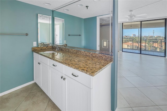 bathroom with tile patterned floors, ceiling fan, a textured ceiling, and vanity