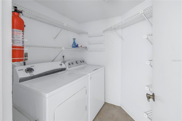 laundry area featuring washing machine and clothes dryer