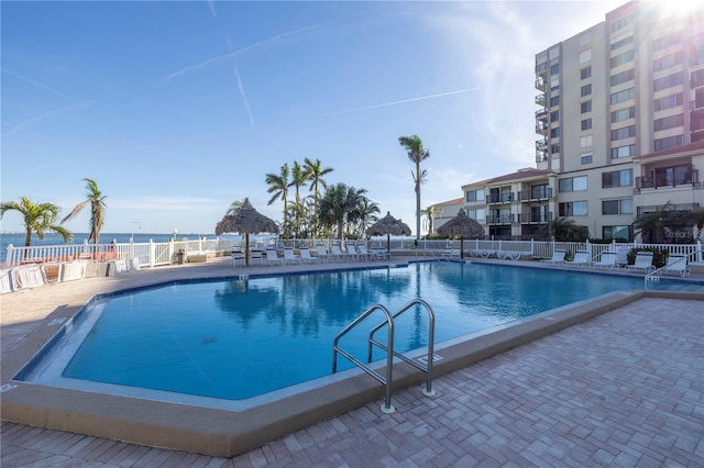 view of swimming pool with a patio and a water view