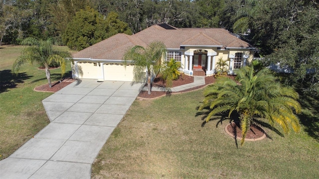 ranch-style home featuring a front lawn and a garage