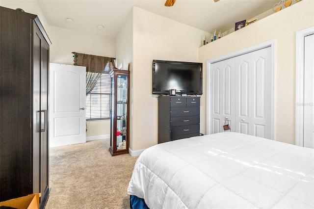 bedroom featuring ceiling fan, a closet, and light colored carpet