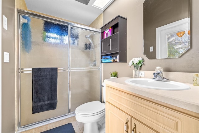 bathroom with tile patterned flooring, vanity, toilet, and an enclosed shower