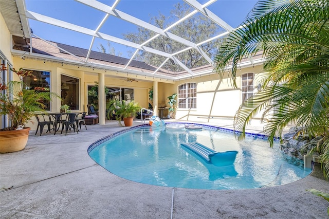 view of swimming pool with a lanai and a patio area