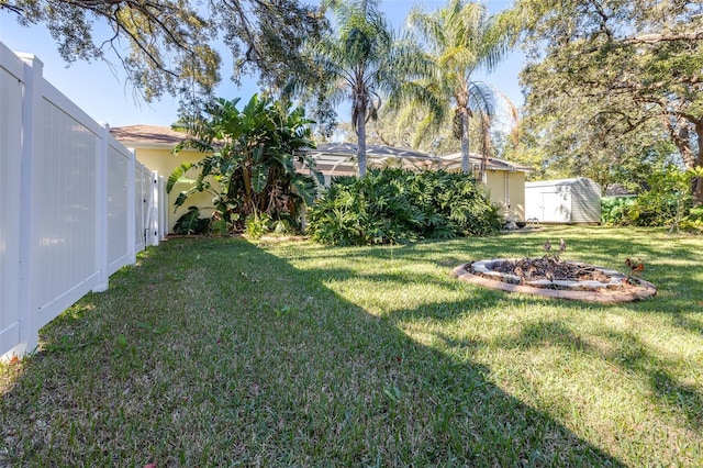 view of yard with a storage shed and a lanai