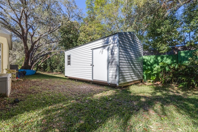 view of outbuilding with a lawn