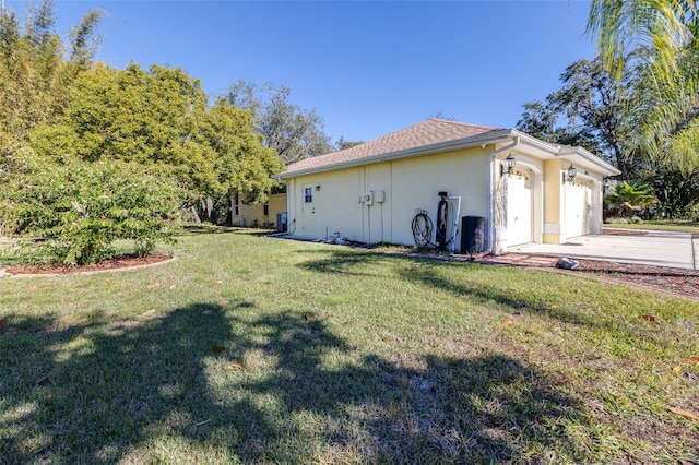 view of side of home featuring a yard and a garage