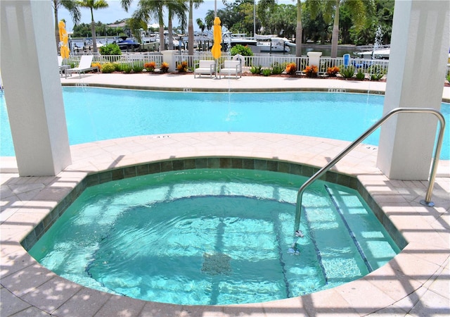 view of pool with a hot tub