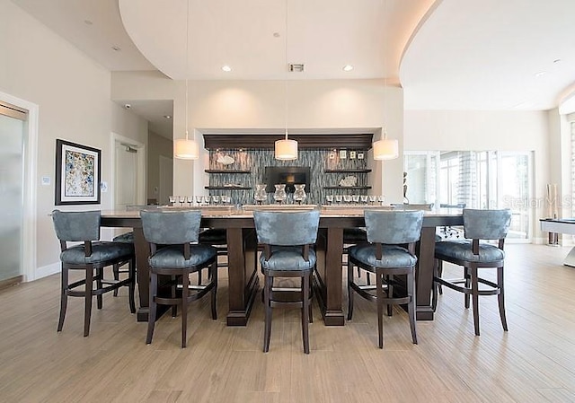 bar featuring pendant lighting, billiards, and light hardwood / wood-style flooring