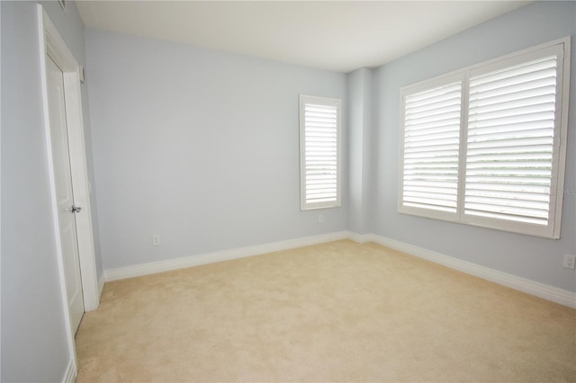 unfurnished room with light colored carpet