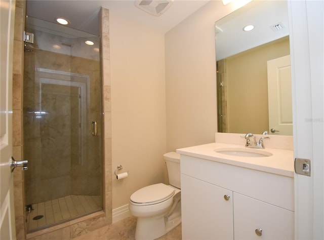 bathroom featuring tile patterned flooring, toilet, a shower with door, and vanity