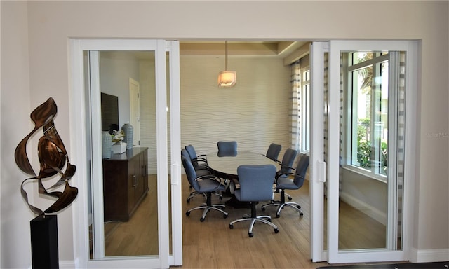 dining area featuring a healthy amount of sunlight and hardwood / wood-style floors