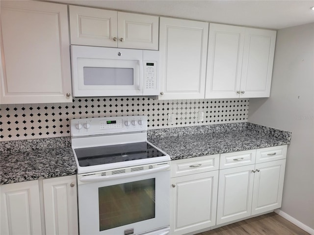 kitchen featuring white cabinetry, decorative backsplash, light hardwood / wood-style flooring, and white appliances