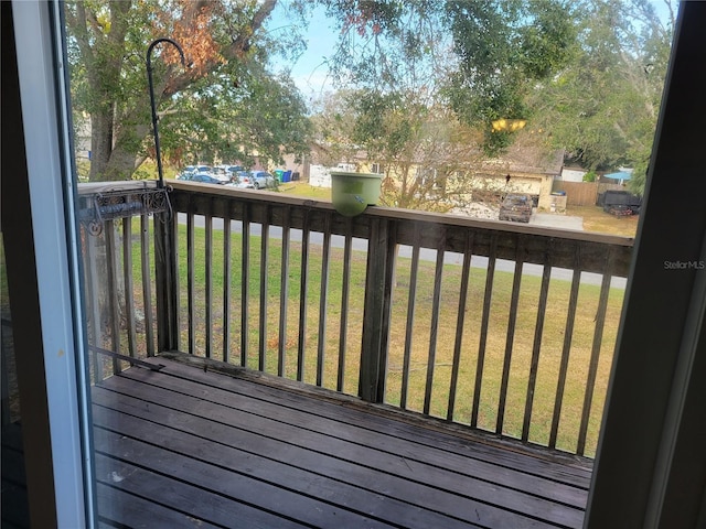 wooden terrace featuring a yard