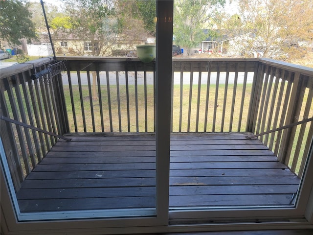 wooden terrace with a lawn