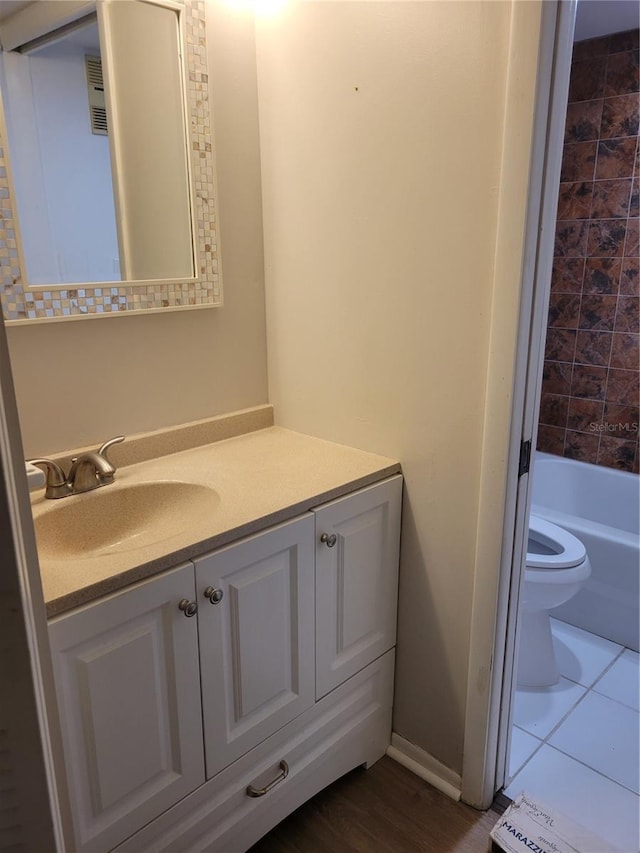 bathroom with tile patterned floors, vanity, and toilet