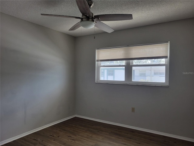 unfurnished room with a textured ceiling, ceiling fan, and dark wood-type flooring