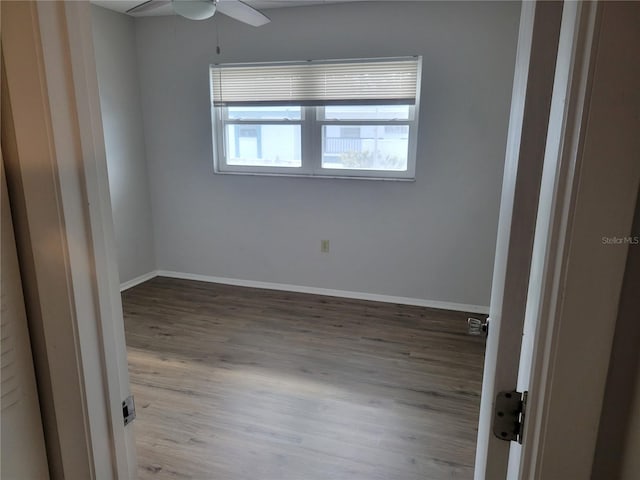 spare room with ceiling fan and light wood-type flooring