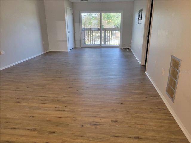 unfurnished room featuring dark wood-type flooring