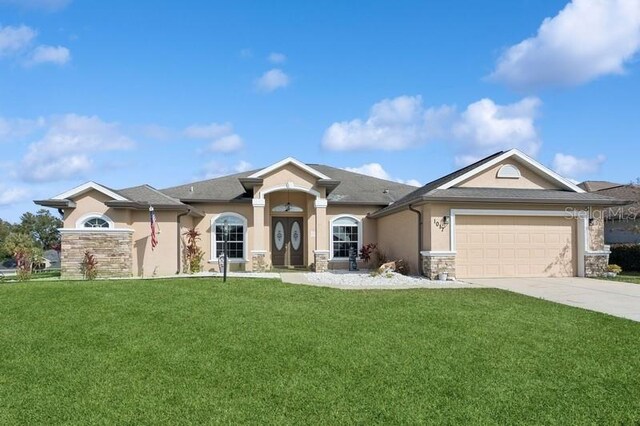 view of front of property with a front yard and a garage