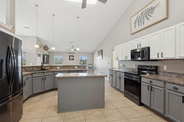 kitchen featuring gray cabinetry, black appliances, white cabinets, hanging light fixtures, and a kitchen island