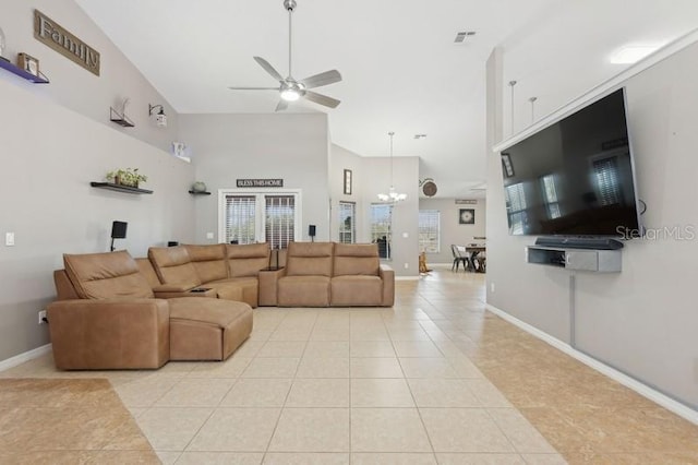 tiled living room featuring ceiling fan with notable chandelier