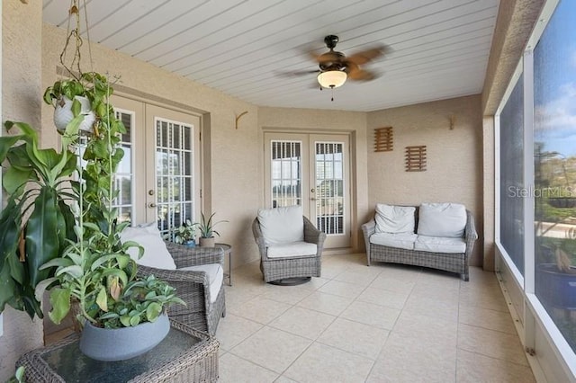 sunroom featuring ceiling fan and french doors