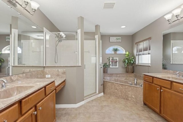 bathroom with tile patterned flooring, vanity, and shower with separate bathtub