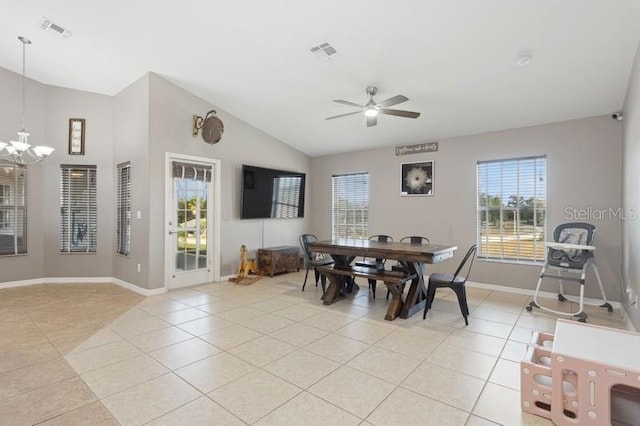 tiled dining area featuring ceiling fan with notable chandelier and vaulted ceiling