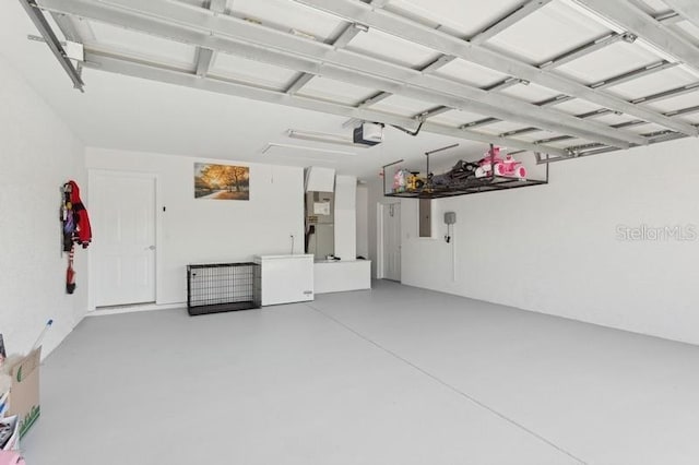 garage featuring a garage door opener and fridge