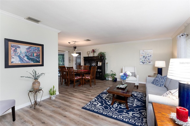 living room with hardwood / wood-style floors, ornamental molding, and a wealth of natural light