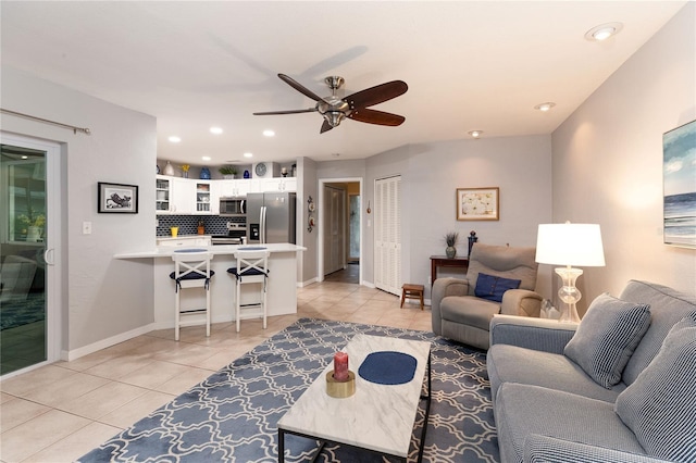 living room with ceiling fan and light tile patterned floors