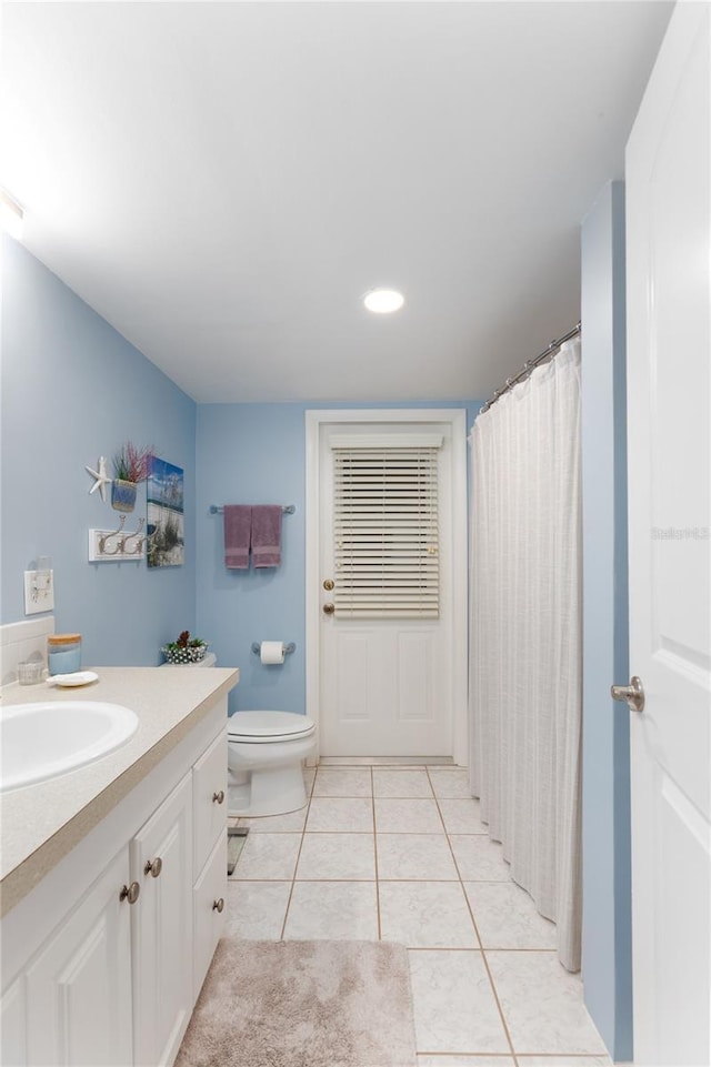 bathroom with vanity, toilet, and tile patterned flooring