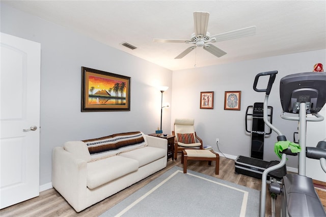 living room featuring ceiling fan and light wood-type flooring