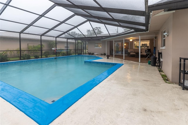 view of pool featuring a patio area and glass enclosure