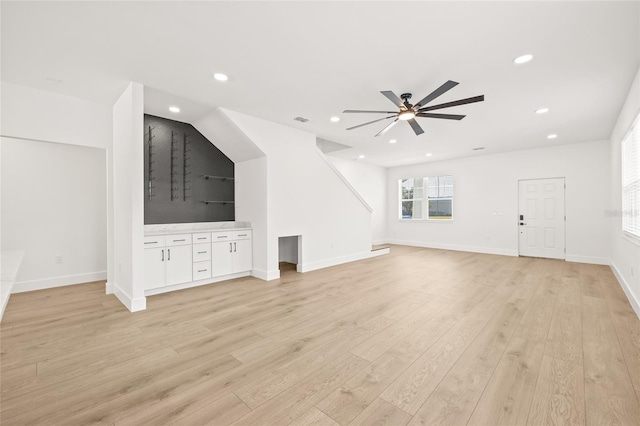 unfurnished living room with light wood-type flooring and ceiling fan