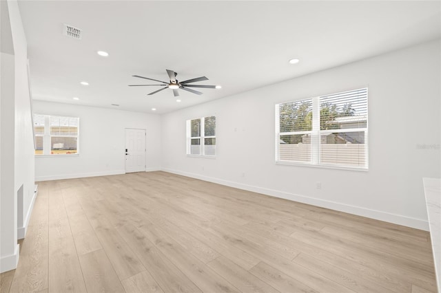 spare room with light hardwood / wood-style flooring and ceiling fan