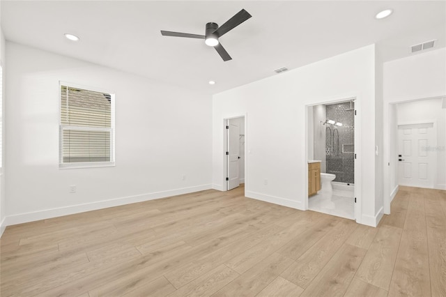 unfurnished bedroom featuring ensuite bathroom, light hardwood / wood-style flooring, and ceiling fan