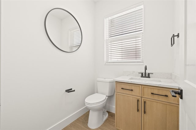 bathroom featuring hardwood / wood-style flooring, vanity, and toilet