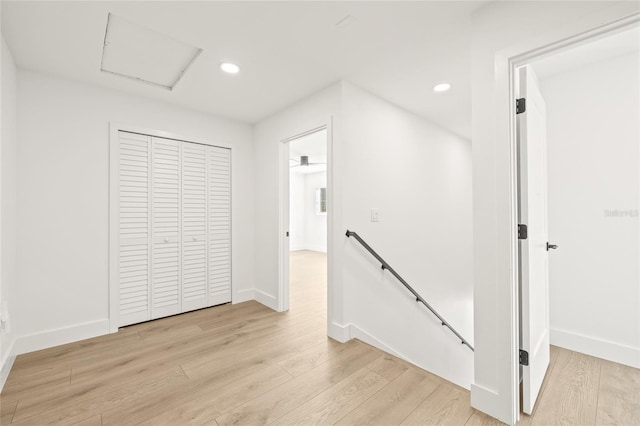 hallway with light hardwood / wood-style floors