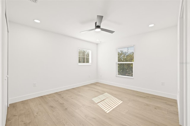 empty room with light hardwood / wood-style floors and ceiling fan