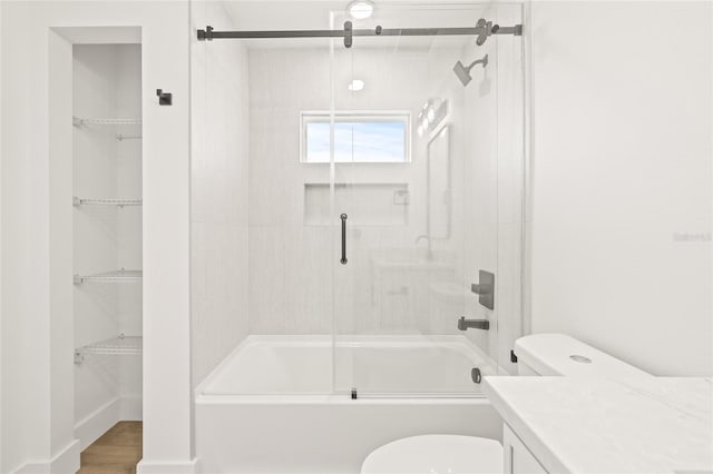 full bathroom with vanity, hardwood / wood-style flooring, toilet, and enclosed tub / shower combo