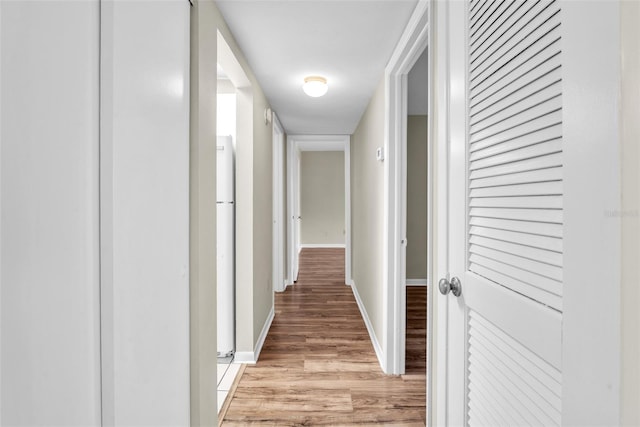 hallway with light hardwood / wood-style flooring