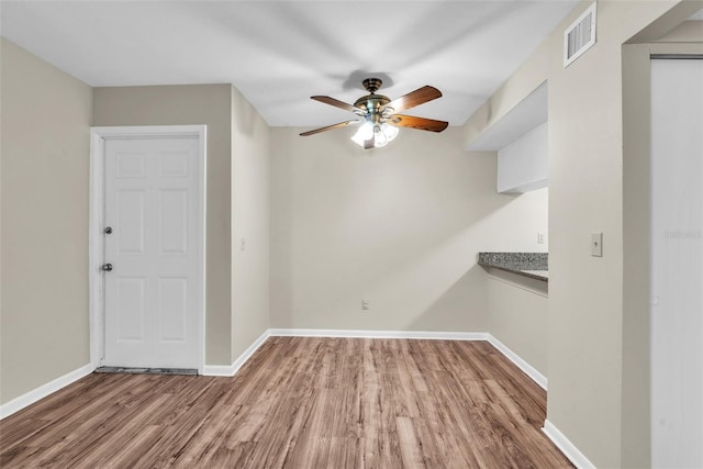 spare room featuring ceiling fan and light hardwood / wood-style floors