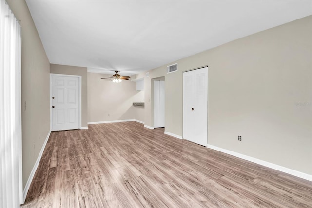 empty room featuring ceiling fan and light wood-type flooring