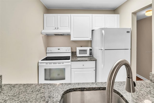 kitchen with white cabinets, white appliances, stone countertops, and sink