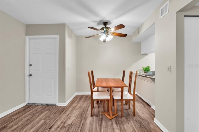 dining space featuring hardwood / wood-style floors and ceiling fan